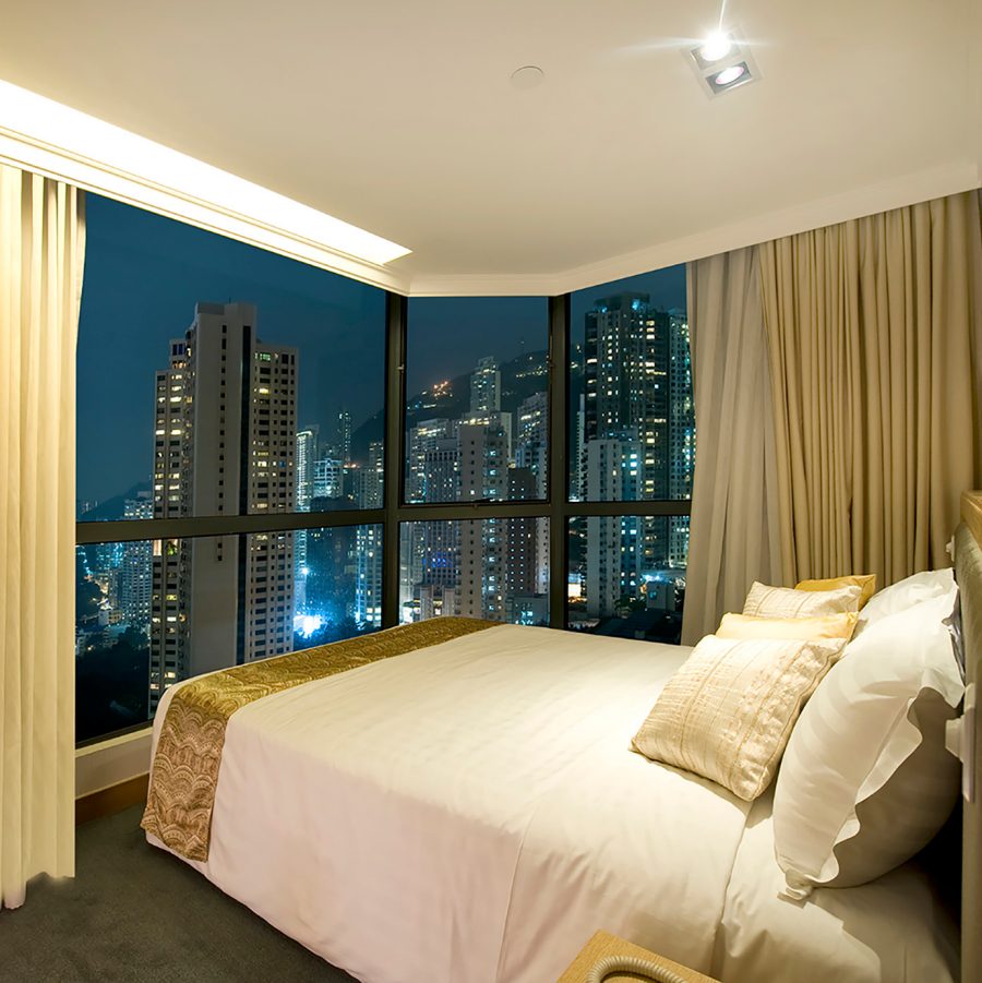 Hotel room at night with view of Hong Kong island skyline